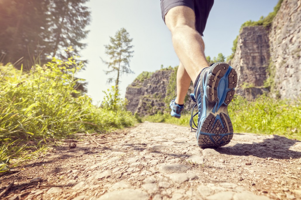 Outdoor cross-country running in summer sunshine concept for exercising, fitness and healthy lifestyle